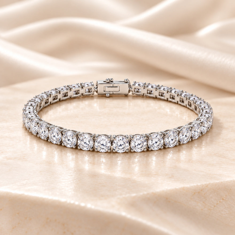 Elegant MARLA Fine Jewellery tennis bracelet featuring a continuous row of sparkling round-cut clear gemstones in polished silver-tone settings on cream marble.
