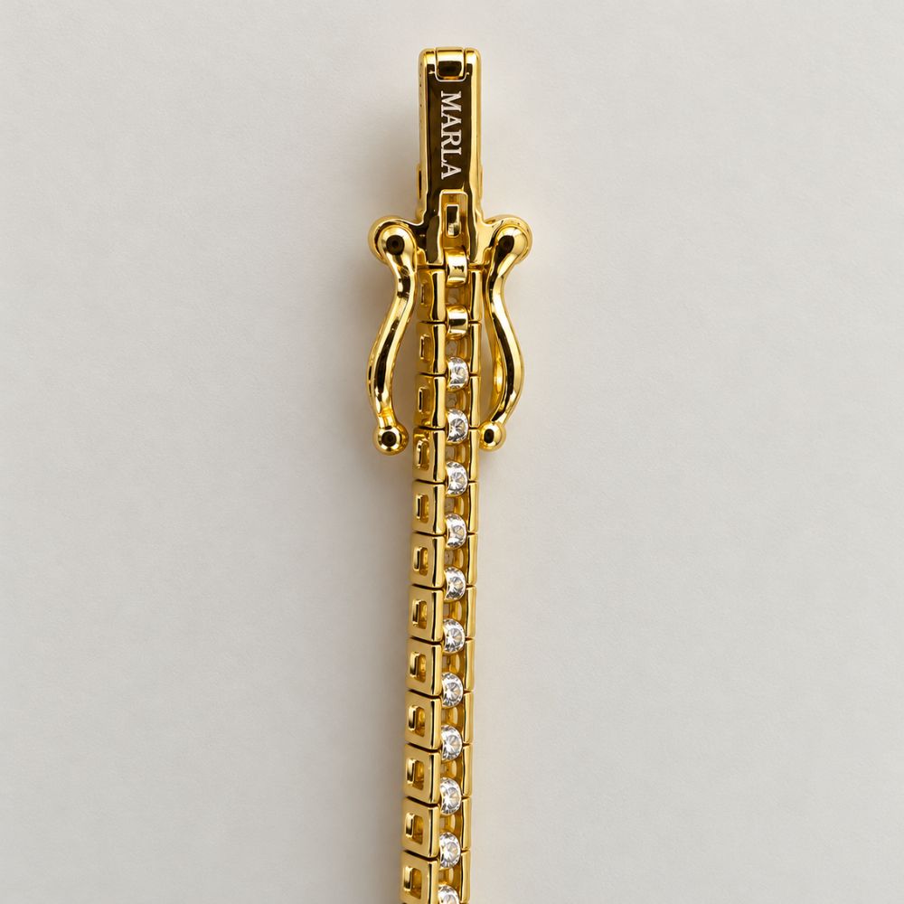 Close-up of MARLA engraved gold clasp on 3mm moissanite tennis bracelet with secure double safety closure.