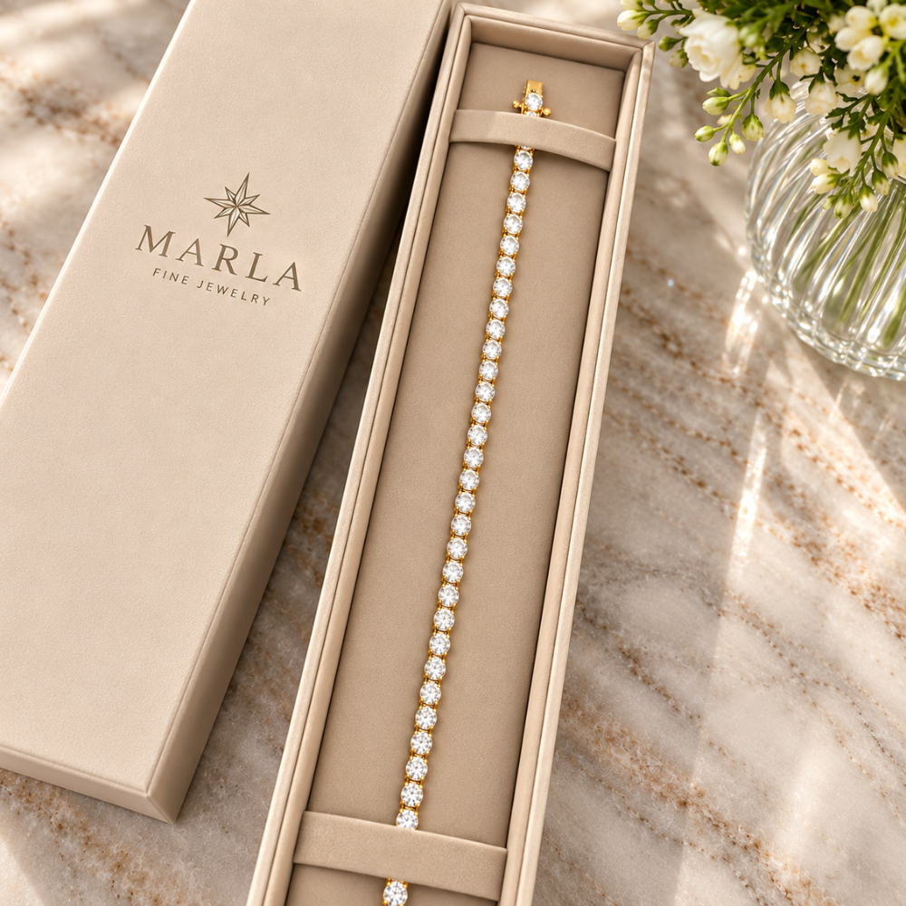 MARLA gold 4mm moissanite tennis bracelet displayed inside a luxury cream jewelry gift box with MARLA branding