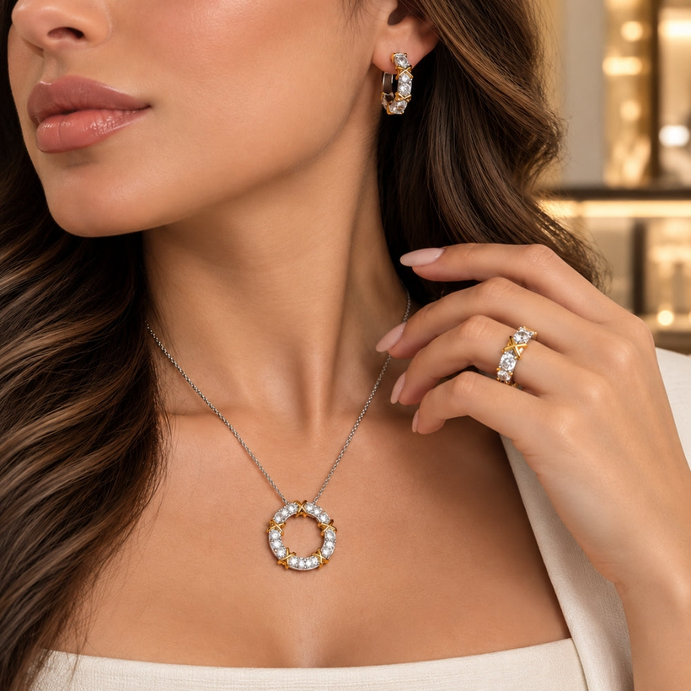 Model wearing the MARLA Celia Jewellery Set, featuring a circular moissanite pendant necklace, matching hoop earrings and statement ring with gold accents.