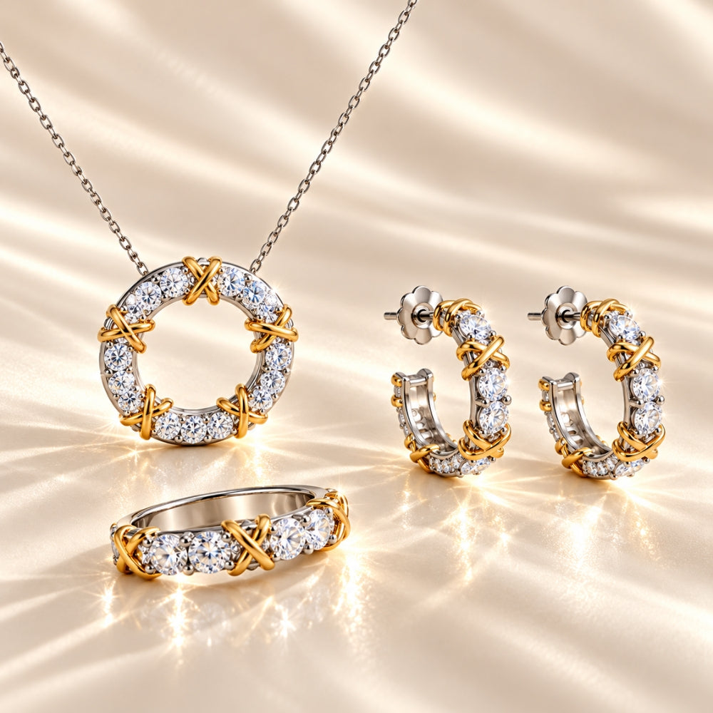 MARLA Celia Jewellery Set featuring a sparkling moissanite ring, circular pendant necklace and matching hoop earrings with two-tone silver and gold accents on luxurious champagne silk.
