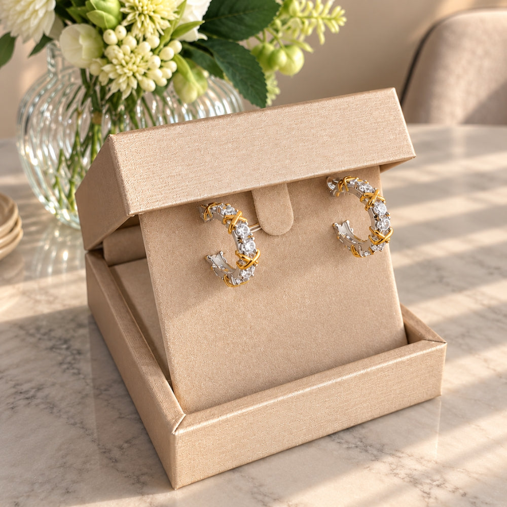 Celia Moissanite Hoop Earrings presented in an elegant champagne-coloured jewellery box, showcasing sparkling moissanite stones and gold accents.