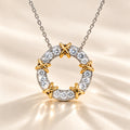 MARLA Celia Necklace featuring a circular moissanite pendant in 925 sterling silver with gold X-shaped accents and sparkling round stones, displayed on a luxury cream satin background.