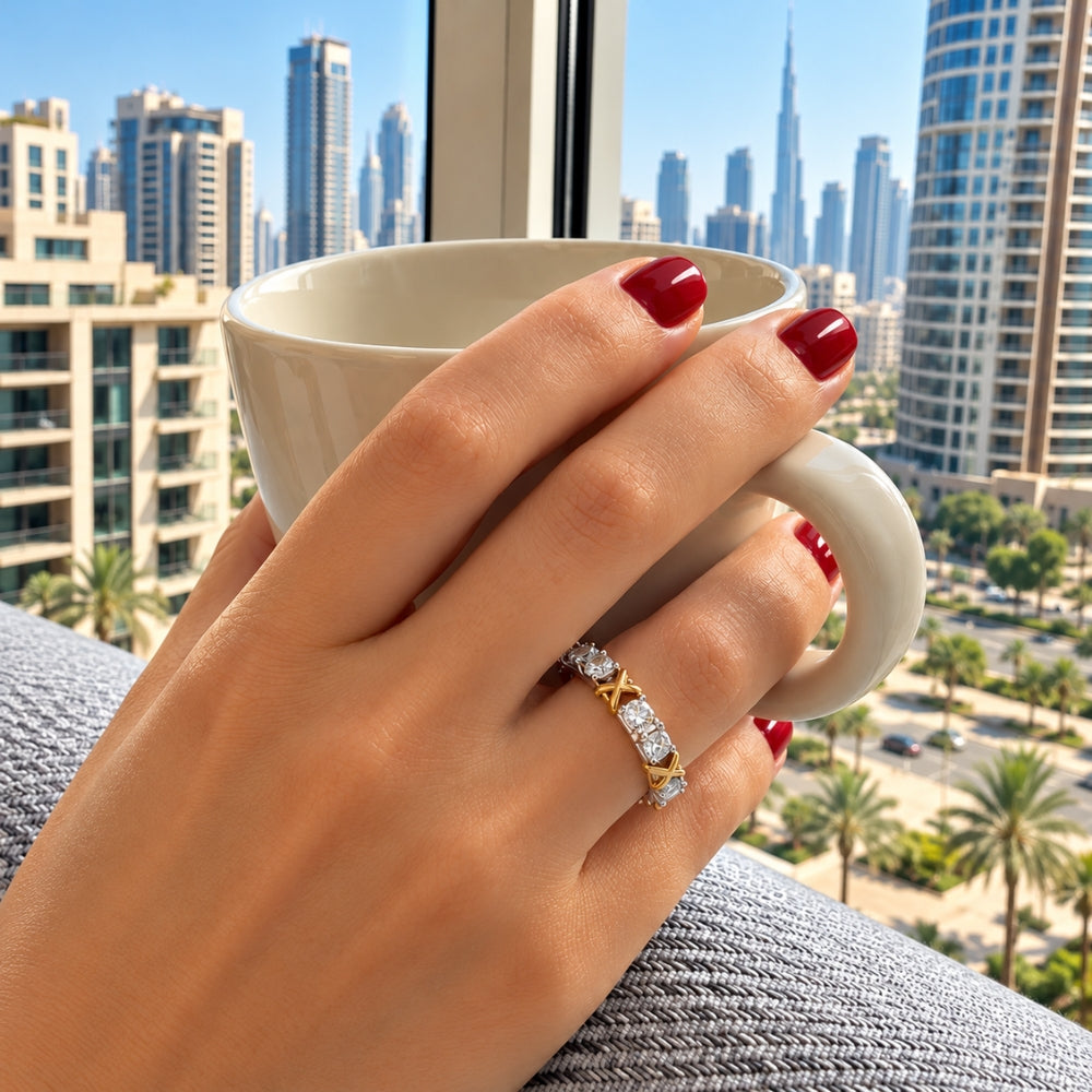 Celia 1.5ct Moissanite Ring by MARLA, worn on a woman's hand holding a coffee cup overlooking the Dubai skyline.