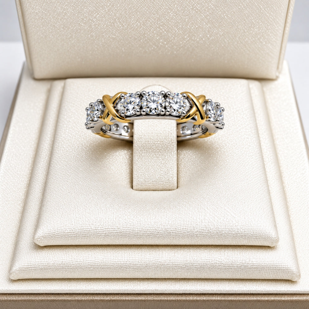 Celia Ring by MARLA, featuring 1.5ct moissanite stones with silver and gold-tone X accents, displayed in an ivory jewellery box.