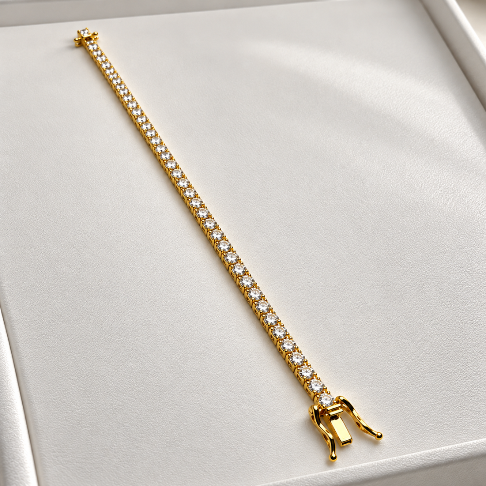 MARLA gold-tone moissanite tennis bracelet featuring sparkling round stones and a secure clasp on a white jewellery display.