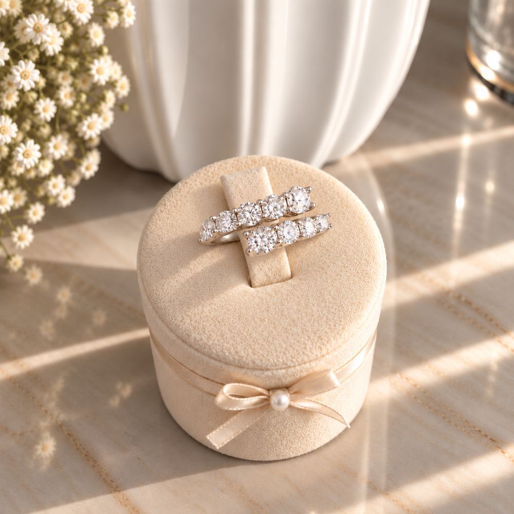 Marla Jewellery silver-tone double-row crystal ring featuring sparkling round-cut stones on an ivory velvet stand with a satin bow and pearl accent.